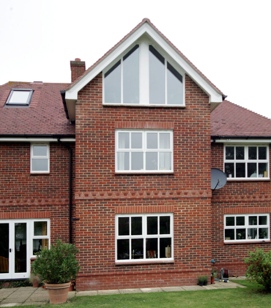 Exterior view of a full height gable end window in a converted loft