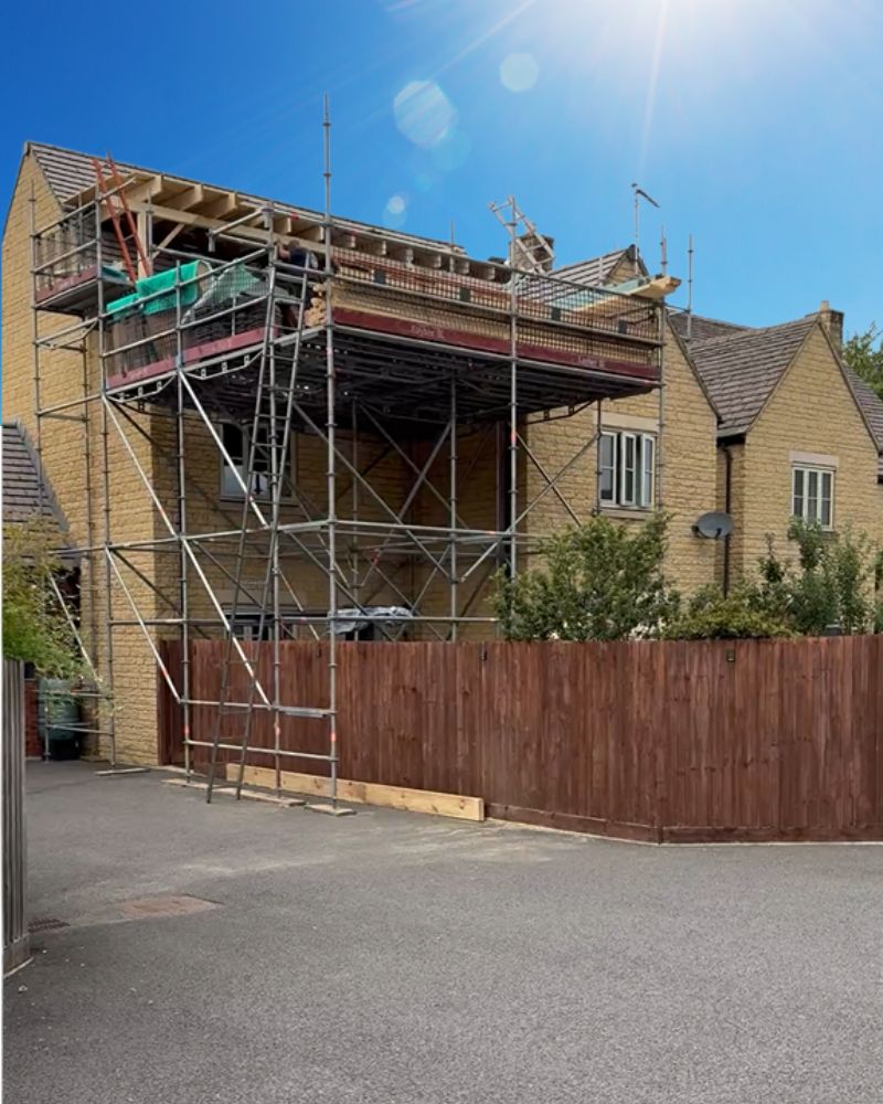 External view of scaffolding on a detached home built in Cotswold stone
