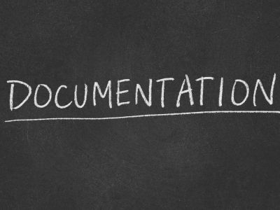 The word documentation written in a chalk type style on a blackboard