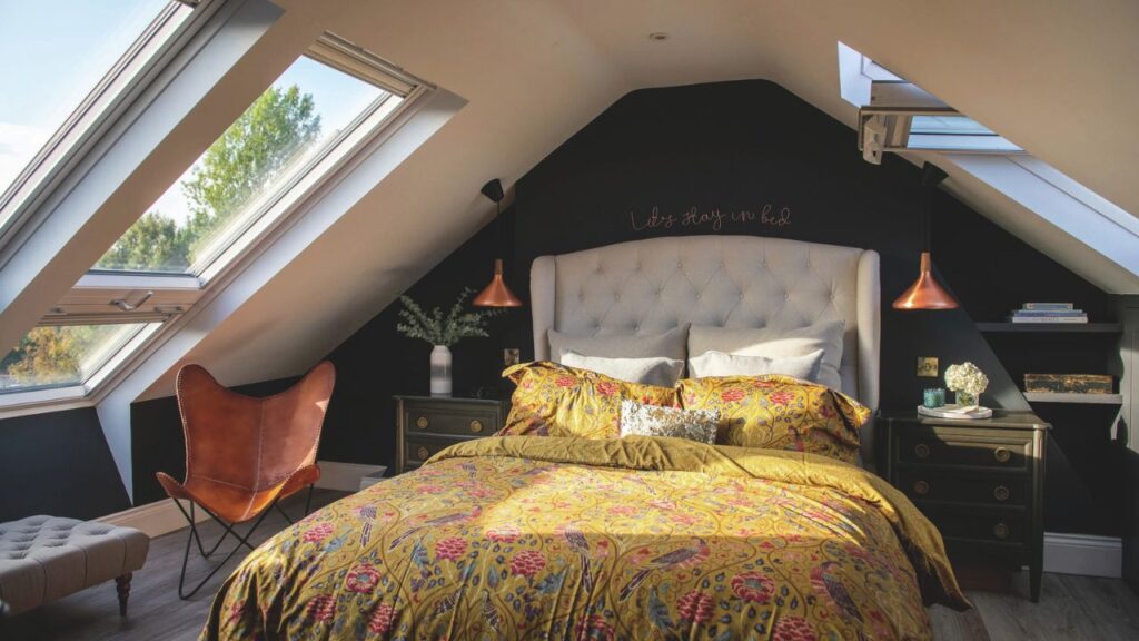 A master bedroom with a luxury double bed, letting in light from three VELUX windows