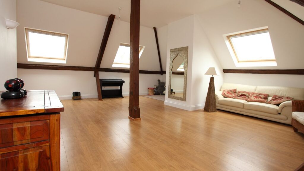 Spacious loft conversion with wooden flooring and three VELUX windows