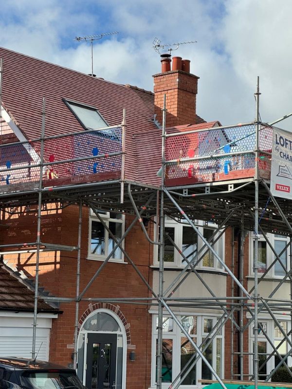 Scaffolding around a semi detached house for a loft conversion by Charles Grosvenor