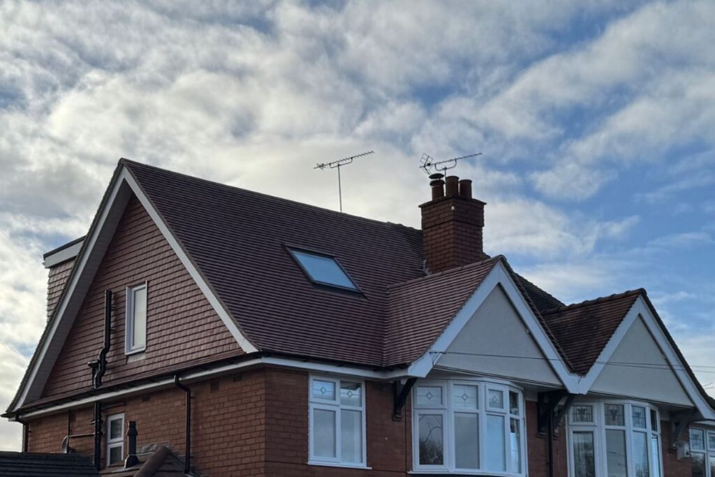 Exterior view of a dormer loft conversion with VELUX window