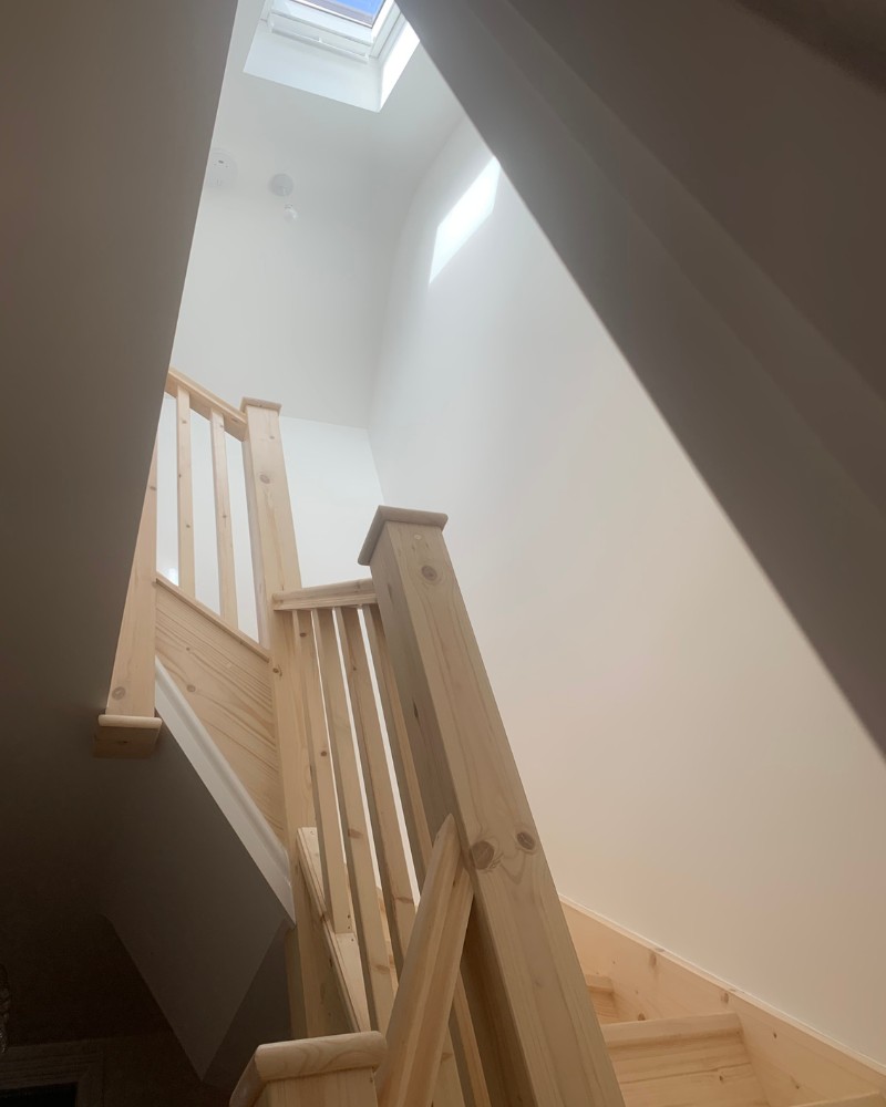 Looking up a newly installed staircase to a VELUX window